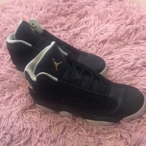 Black Jordan 13’s with a teal accent